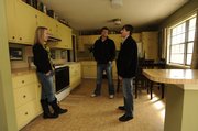Brianne Kuester and Matt Whitesell, center, talk with Nicholas Lerner about a home for sale in west Lawrence. Lerner works for McGrew Real Estate.