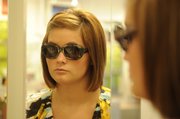 Mallory Zornes, an employee for Wink Eyewear, 806 Mass., models L.A. Eyeworks sunglasses, which start at $200.