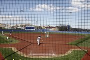 The Kansas University women’s softball team practices at Arrocha Ballpark on Monday while, across campus, university and athletics officials met with the public to discuss a plan to build an “Olympic Village” sports complex at KU.