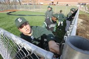 FSHS new bsseball field is almost ready as Michael Lisher and other team memebers work on putting on the wind screen on Thursday April 2nd, 2009.