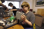 Jesse Jacob, 14, Central Junior High School student, learns Saturday how to take apart a computer as part of a Youth Education Association program at the United Way Building at 2518 Ridge Court. He was one of six children attending.