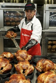 A worker prepares chicken for sale at Costco in Mountain View, Calif. Costco Wholesale Corp. hasn’t eliminated workers because of the recession. To be sure, discounters like Costco are faring better than other merchants as frugal consumers hunt for deals and stick to basics like groceries and health products. “We need our workers,” said Bob Nelson, vice president of financial planning and investor relations at Costco. “You have to have the people to get customers in and out.”