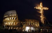 A large, fire-lit cross overlooks the ancient Colosseum prior to the start of the Good Friday Via Crucis (Way of the Cross) torchlight procession, celebrated by Pope Benedict XVI before the ancient monument on Friday in Rome. The evening Via Crucis procession at the ancient amphitheater is a Rome tradition that draws a large crowd of faithful, including many of the pilgrims who flock to the Italian capital for Holy Week ceremonies before Easter Sunday.