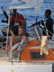 In this undated photo released by the French Defense Ministry on Saturday, armed pirates and their hostages are seen aboard the French yacht “Tanit” off the coast of Somalia. The pirate scourge off the Somalian coast has greatly increased over the past year.