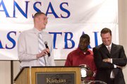Kansas center Cole Aldrich, left, entertains the crowd at the basketball awards banquet April 13 at the Holidome, next to Sherron Collins, center, and coach Bill Self. Aldrich and Collins recently expressed no regrets in electing to stay in school for another year. The NBA Draft is tonight in New York.