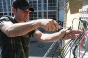 Duane Robinson installs wires during a class on solar panels recently at San Jose City College in California. Students and colleges are betting that President Barack Obama’s campaign to promote alternative energy and combat global warming will create millions of green jobs that pay well, cannot be outsourced and do not require a four-year degree. See story, page 7B.
