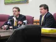 Duane Goossen, left, Gov. Kathleen Sebelius’ budget director, and Alan Conroy, director of the Kansas Legislative Research Department, explain the latest revenue estimate for the state budget. The news wasn’t good: Revenue estimates were revised downward $328 million.