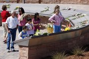 Flowers are placed on the plaques to the 13 victims of the massacre at Columbine High School to mark the 10th anniversary of the killings, at Columbine Memorial in the southwest Denver suburb of Littleton, Colo., on Monday, April 20, 2009.