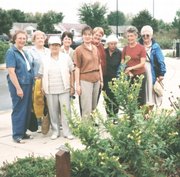 Green Thumb Garden Club members admire the permanent horticulture identification markers, shown on the post in foreground, they donated to Prairie Park Nature Center, in this 2002 photo. From left are Mary Margaret Rowen, Virginia Williams, Isabelle Schaake, Ann Phillips, Trudy Walker, Alicia Rieder, Gertrude Tweddell, Wanda Waugh and Jane Jewell.