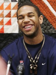 Star recruit Xavier Henry laughs during a news conference in which he announced his decision to play basketball at Kansas University. Henry made the announcement on Thursday at his Putnam City (Okla.) High School.