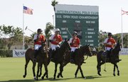 Players on the Audi polo team ride their horses onto the field Thursday during the semifinals of the U.S. Open Polo Championships at the International Polo Club Palm Beach in Wellington, Fla. Twenty-one polo horses from the Venezuelan-owned team Lechuza died Sunday.