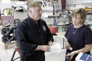 Lloyd Hetrick, fixed-base operator at Lawrence Municipal Airport, verifies with Janice Smith that a part has been ordered for an aircraft undergoing repairs.