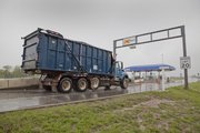 A Lawrence trash truck goes through the K-Tag turnpike toll gate to enter Interstate 70 from North Iowa Street on a Thursday morning in April