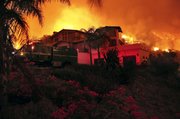 A U.S. Forest Service fire engine is in place on Thursday at a home that is threatened by an approaching wildfire in Santa Barbara, Calif.