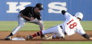 Free State shortstop Colin Toalson puts the tag on Lawrence Lion runner Aaron Rea during a game Thursday night at KU's Hoglund Ballpark.