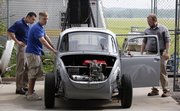 From left, instructor Chris Depcik and students Ryan Lierz and Lou McKown, along with other KU engineering students, have built a hybrid car using a 1974 Volkswagen Super Beetle. It starts on biodiesel and then runs on an electric motor.
