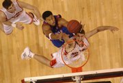 Wayne Simien fights for a rebound over Nebraska’s John Turek as Jake Muhleisen watches on in this 2005 file photo. Simien has returned to Lawrence to pursue a career in ministry.