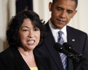 President Barack Obama listens to his Supreme Court nominee Sonia Sotomayor speak Tuesday in the East Room of the White House in Washington.
