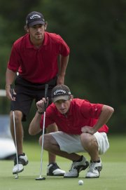 Brothers Kyle, left, and Curtis Yonke line up a putt on the 14th hole of the Kansas Four-Ball Championship. The Yonkes won the tournament’s open division Friday at Alvamar public.