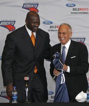 Michael Jordan presents a jersey to introduce Larry Brown as coach in this April 29, 2008, file photo in Charlotte, N.C. Brown expressed concern in Jordan’s recent unknown role with the franchise.