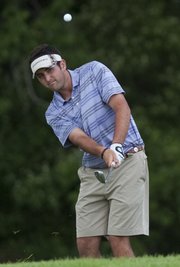 Bobby Knowles chips onto the 18th green during the Kansas Four-Ball Championship. Knowles and Andrew Storm fell to Kyle and Curtis Yonke in the Open Division finals Friday at Alvamar public.