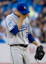 Kansas City pitcher Zack Greinke wipes his brow during the fourth inning where he gave up four runs to the Toronto Blue Jays. The Royals lost, 9-3, Friday in Toronto.