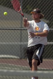 Action continued Saturday in the Lawrence Open tennis tournament. Derek Gillilan of Higginsville, Mo., returns the ball in quarterfinals men's open.