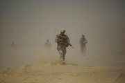 U.S. Marines from the 2nd Marine Expeditionary Battalion walk through the sand Monday inside Camp Leatherneck in Afghanistan’s Helmand province. New U.S. troops ordered to Afghanistan are fanning out across the dangerous south on a mission to defeat the Taliban insurgency and to change the course of a war claiming American lives at a record pace.