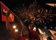 Two Lebanese women, supporters of pro-Western candidate Nadim Gemayel, the son of slain former President-elect Bashir Gemayel, celebrate his victory under fireworks Monday in Beirut, Lebanon.
