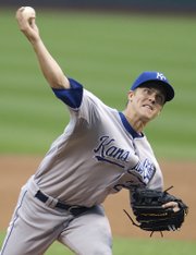 Kansas City Royals pitcher Zack Greinke delivers to Cleveland Indians’ Mark DeRosa in the first inning. The Royals lost, 4-3 in 10 innings, Thursday in Cleveland.