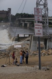 Lawrence police Friday morning were ticketing people trespassing on Bowersock Dam in the wake of last week's near drowning of a 14-year-old Lawrence teen.