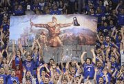 The Jayhawk student section displays an enlarged and modified version of artist John Steuart Curry’s Tragic Prelude painting which features abolitionist John Brown holding a rifle and in this case the 2008 national championship trophy at the men’s basketball game against Missouri on March 1 at Allen Fieldhouse.