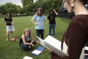 Members of the Lawrence Youth Ensemble prepare to rehearse a scene from “Home on the Road” last week in Watson Park. From left are Natasha Hurt, 12, ensemble co-director Rachael Perry, Anna Taylor, 14, Rob Parker-Ortley, 16, and Emily Reno, 14. The nine-member ensemble wrote the play, a series of vignettes about Lawrence, and will perform it three times this weekend.