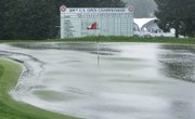 Water floods the 18th green at the Bethpage State Park’s Black Course on Thursday in Farmingdale, N.Y. Play was halted during the first round of the U.S. Open and will resume today.