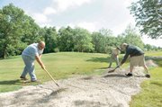 Groundkeepers Gordy Lowe, left, James Tonner, right, and Zach Woodrow at work at Deer Creek state park golf course May 29 in Mount Sterling, Ohio. Despite strict limits on adding new employees imposed last year, Ohio still hired 17 administrators earning six-figure salaries, two workers for state park golf courses and a prison chaplain, records show. The golf course workers were hired for state-run courses at Deer Creek State Park south of Columbus and Shawnee State Park in southern Ohio. The state’s six golf courses bring in nearly $2 million a year in greens fees, and these workers are critical to maintaining that revenue stream, said Natural Resources spokeswoman Beth Ruth.