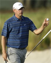 Lucas Glover waves his ball after his putt on the 16th green during the second round of the U.S. Open on Friday in Farmingdale, N.Y. Glover is the early leader through part of the second round. Story on page 8C.