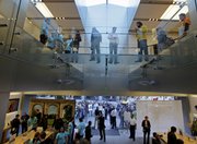 People wait on a bridge inside and on the sidewalk outside an Apple store Friday to purchase the new Apple iPhone 3G S in San Francisco. For new customers signing a two-year contract with AT&T, the 3G S costs $199 or $299 depending on the memory capacity. Compared with the 3G, it has a faster processor and an upgraded camera.