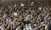 Holding posters of the late Iranian spiritual leader Ayatollah Khomeini and supreme leader Ayatollah Ali Khamenei, worshippers chant slogans during Friday prayers at the Tehran University campus in Tehran, Iran.