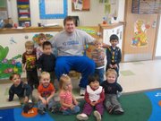 Kansas offensive lineman Brad Thorson poses for a photo during the Jayhawks’ READ event at Hilltop Child Development Center. Student-athletes make numerous visits to local elementary
schools throughout the year to read to young students.