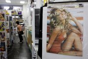 A poster of actress Farrah Fawcett is displayed for sale Thursday at Hollywood Book in the Hollywood section of Los Angeles. Fawcett died Thursday at the age of 62.