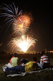 Using a technique that allowed me to layer several firework bursts onto one frame, I captured this image from last year’s Fourth of July display. I also fired a flash on each side to illuminate the foreground subjects. The photo was taken with a 28mm lens on a Nikon D300 with an ISO setting of 200 and a manual exposure setting of f13 at 44 seconds.