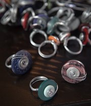 Michelle Merritt makes homemade rings out of old buttons that she is selling to raise money for an international adoption.