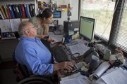 Kevin Anderson/Journal-World Photo
Glen White works with Chiaki Gonda, a graduate research assistant, as they look for photos from a trip to Peru.