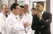 President Obama talks with Dr. Mark Anderson while touring a cardiology research lab before speaking about his health care plan at the University of Iowa in Iowa City, Iowa. A new book documents the legacy of other presidents’ attempts at introducing health care legislation.