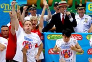 Joey Chestnut, left, of San Jose, Calif., defending champion of the Nathan’s Famous July 4th Hot Dog Eating Contest, celebrates his victory, logging his third consecutive win with a world-record 68 franks over former champion Takeru Kobayashi of Nagano, Japan, July 4, 2009, in New York. A frank. A wiener. A hot dog. Call it what you will, but our nation can’t get enough of them.
