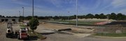 The track surface is down and workers are installing blocks for seating on the west side of the new Lawrence High football field on Tuesday.