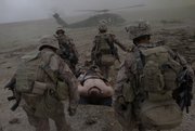 Medics attached to the 2nd Marine Expeditionary Brigade, 1st Battalion, 5th Marines, carry a Marine who was overcome by heat exhaustion Monday to a medical evacuation helicopter in the Nawa district of Afghanistan’s Helmand province.