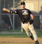 Raiders Third baseman Brian Kindle throws out an Olathe South runner in the fifth inning. O-South beat Lawrence, 8-7, Wednesday at Ice Field.