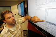 Shawn White, Director of External Operations for mobile and Web site monitoring company Keynote Systems, points Wednesday to a graph of the Department of Defense Web site performance, top graph, and availability, lower graph, at the company’s headquarters in San Mateo, Calif. This graph shows very poor availability and performance of the DOD Web site on Monday.