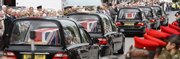 Soldiers and local townspeople line the street as the bodies of five British servicemen are driven though the small town of Wootton Bassett, England, Friday following their return from Afghanistan.